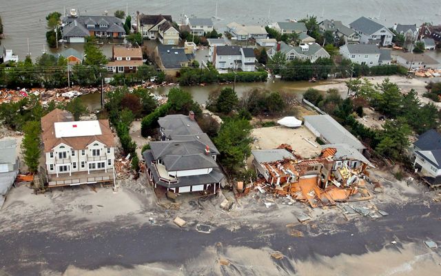 Damaged, sand-covered and flooded houses along the NJ coast.
