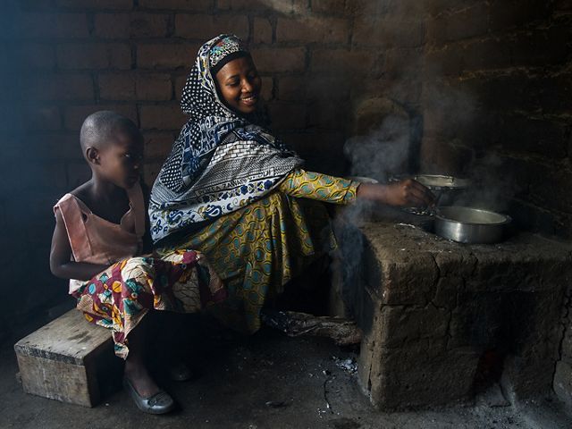 woman cooking on outdoor stove