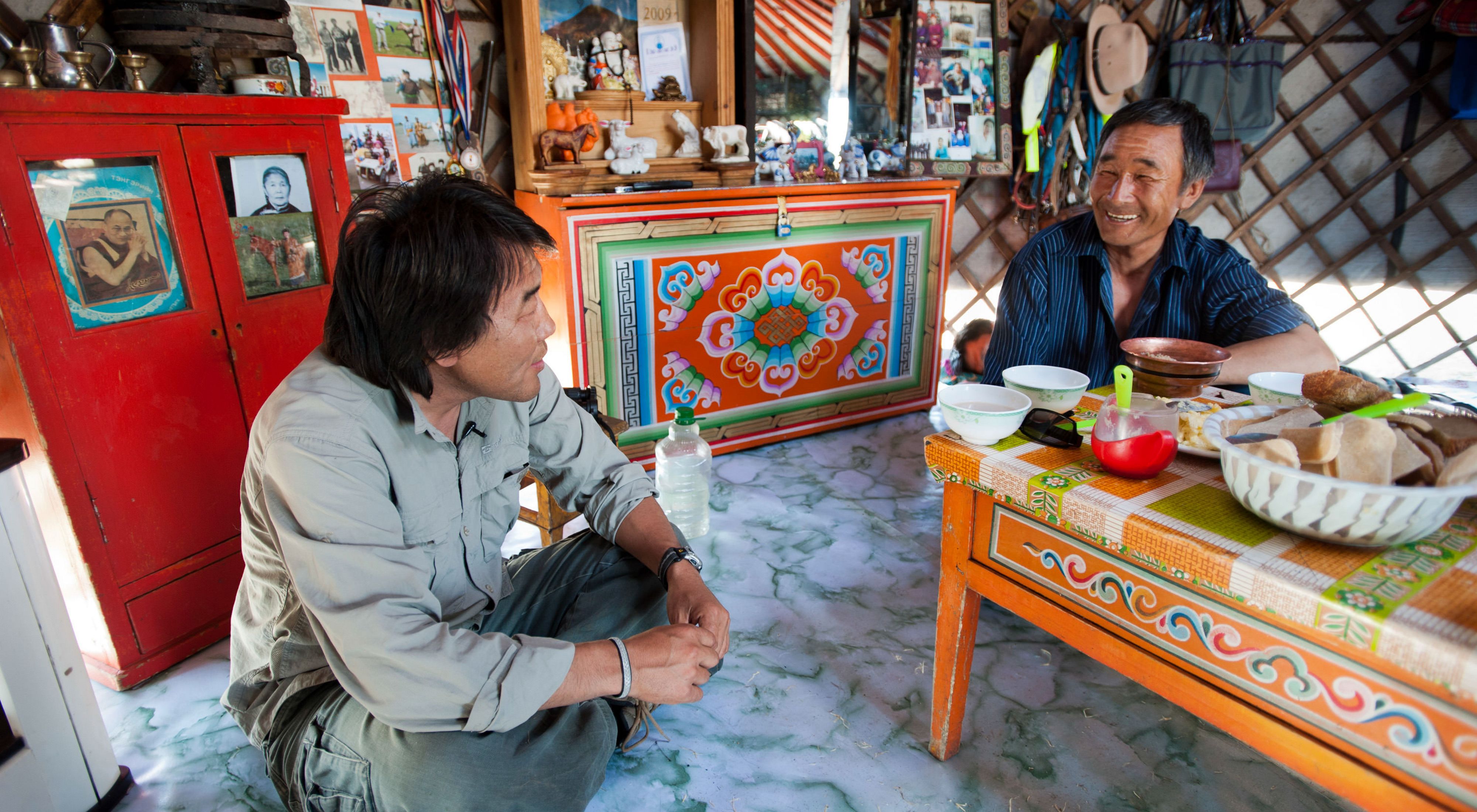 Gala Davaa, TNC Country Director of Mongolia, sits with a Mongolia header over a meal.