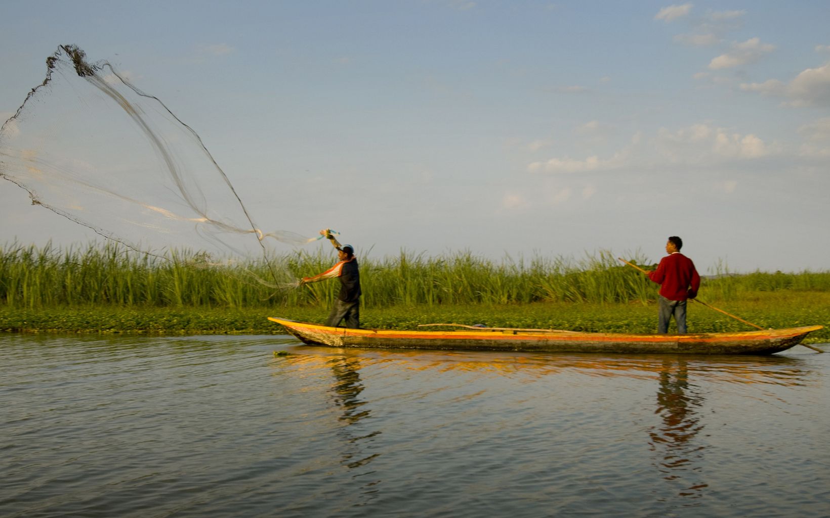 
                
                  Local fishermen casting nets The Totumo Lagoon (in the lower Magdalena River basin), a freshwater lagoon near the town of Lomitarena, Colombia. 
                  © Bridget Besaw
                
              