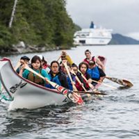 Interns practice paddling a traditional canoe in the Great Bear Rainforest region of British Columbia, Canada.