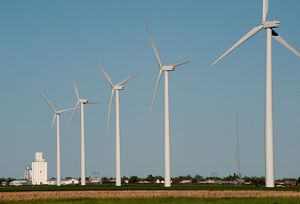 A row of turbines tower over the flat landscape at a wind facility in Kansas.
