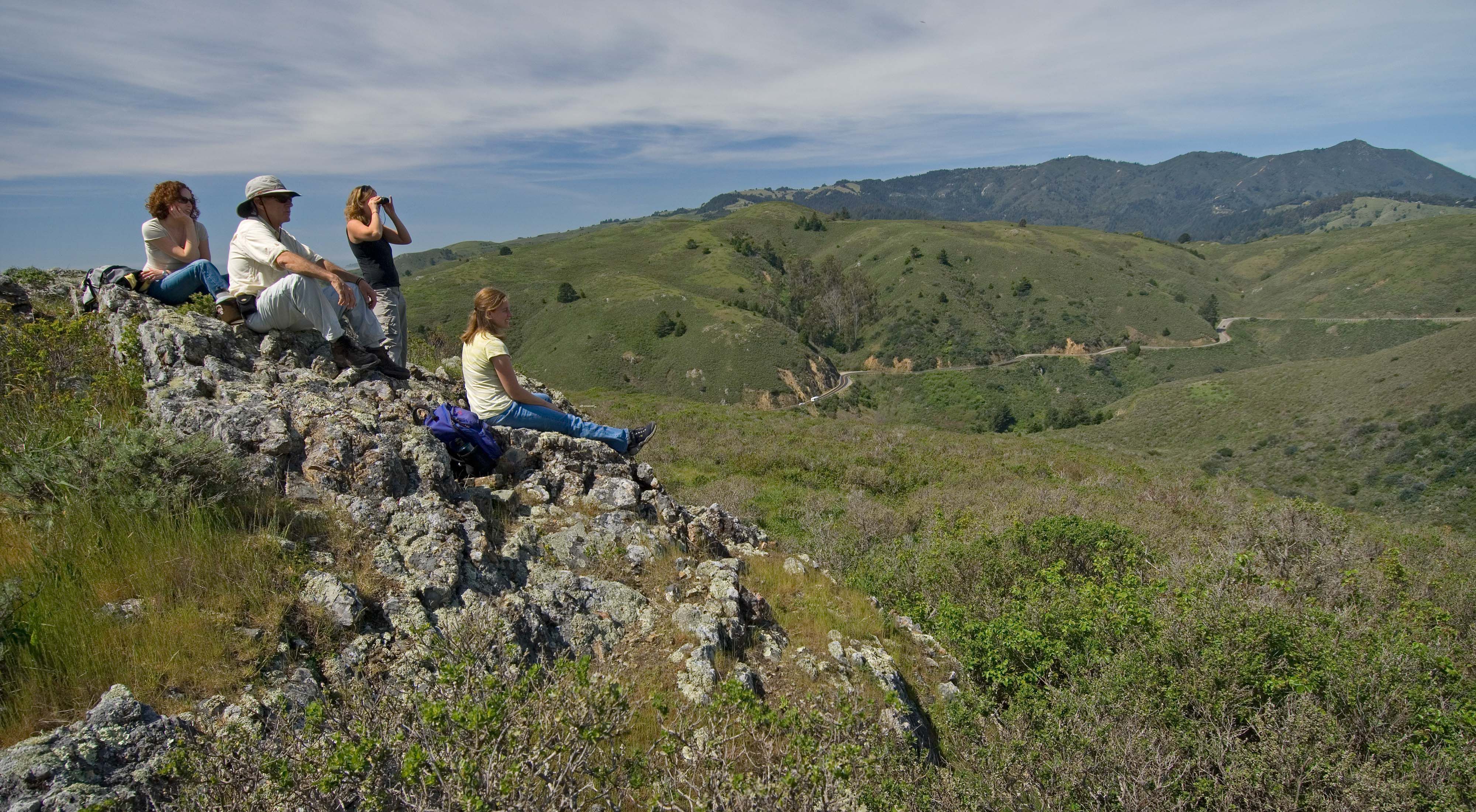Conservancy staff pause to bird watch while hiking the Green Gulch trail above the Pacific coastline in California's Golden Gate National Recreation Area. 