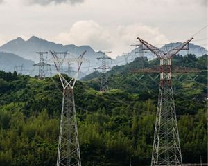 View of high voltage power lines on a mountain range.