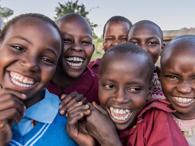 school children smiling at camera