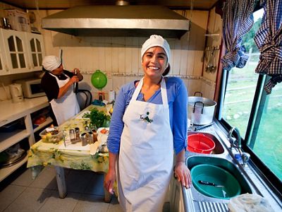 Chaithuln, Chile near Valdivia Coastal Reserve: Chef Teodora Leal (featured) and colleage Silvia Railaf (background) cooking mussells at their sustainable restaurant, Fondo Marino.