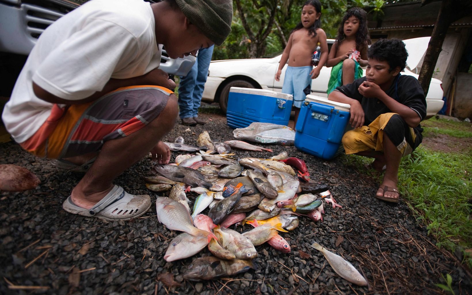 Members of the Paulino family examine their catch some of which they will sell to other members of their village community.