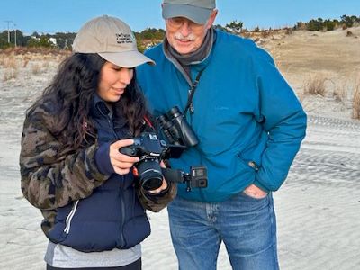 Sophia and Fred at Run Hill looking at a camera.