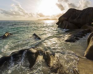 in the surf and sand define the coastlines of Seychelles's inner islands.