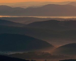 Pre-dawn scene looking across mist-shrouded Appalachian valleys and ridges.