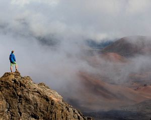 A TNC staffer stands on a rock inside the creater of Haleakala National Park, Maui, Hawaii.