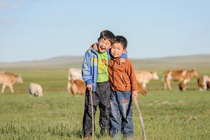 Two Mongolian boys smiling.