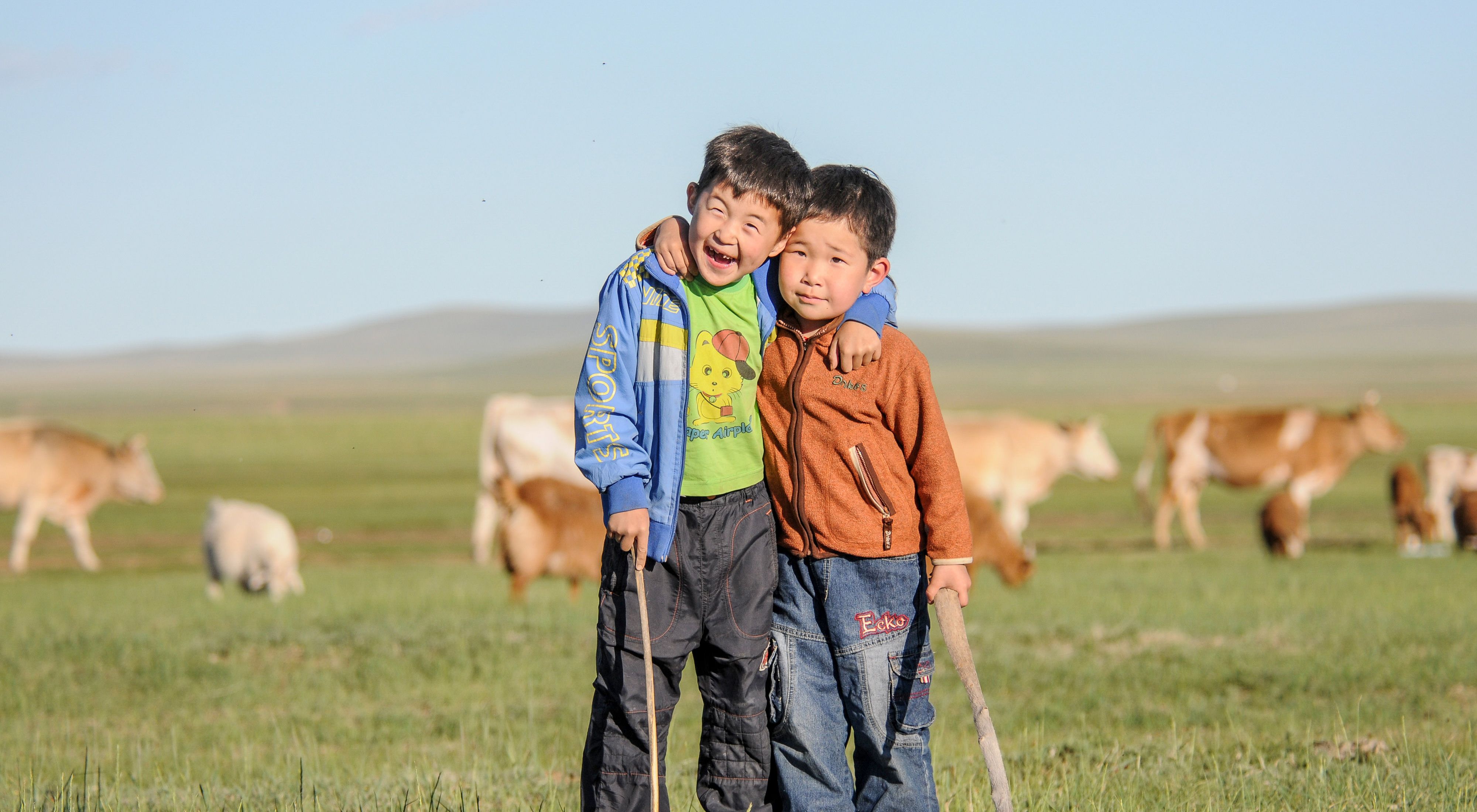 Two Mongolian boys smiling.