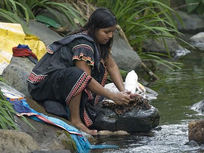 A woman washes clothing 