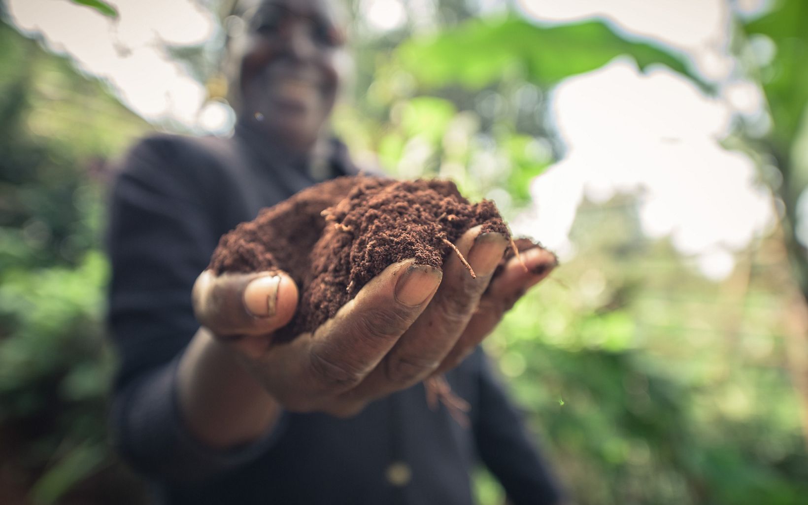 Jane Kibugi holding fresh soil on her hillside farm in the Upper Tana Watershed, Kenya.  June 2015