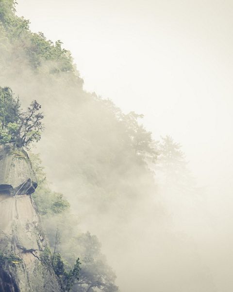 Misty mountain ridge in Laohegou Nature Reserve in China.