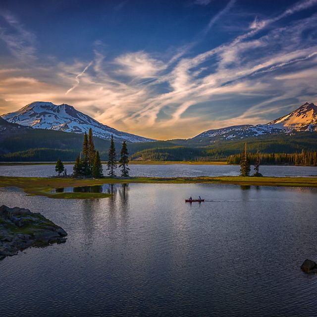 Evening Paddlers on Sparks Lake along the beautiful Cascade Lakes Scenic Byway in Bend, Oregon.