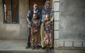 The Katunka family stands in front of their home in the village of Mgambo near Lake Tanganyika in western Tanzania. They are considered a Class One Model Household family and practice positive health and environmental behaviors and encourage their fellow community members to adopt these behaviors in their own households.
