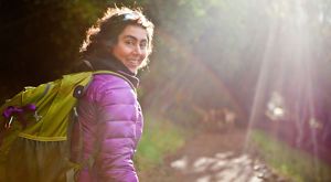 Waterfall in a mossy, heavily wooded area.