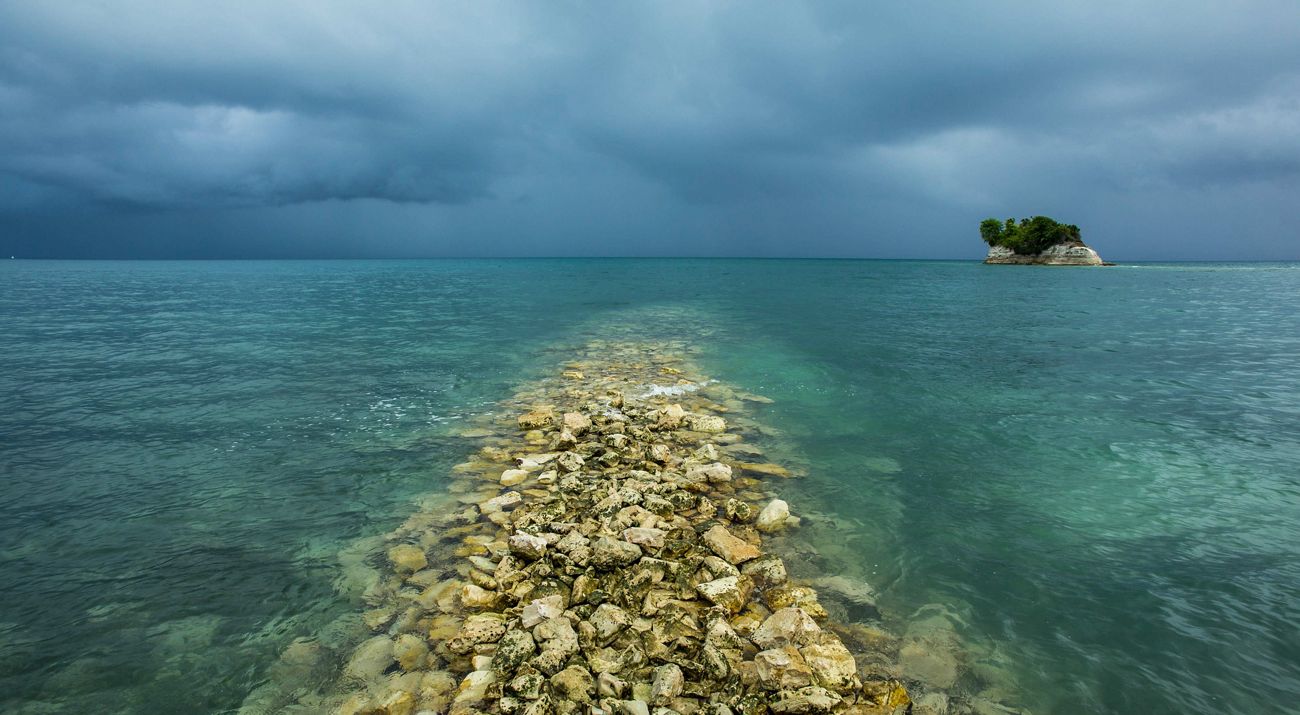Blue ocean waters under a stormy sky.