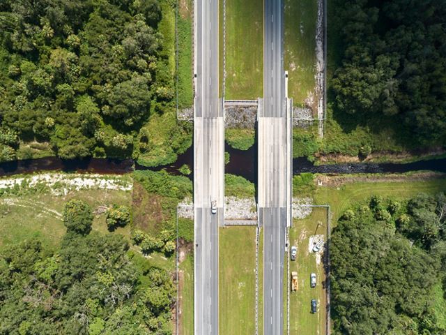 An aerial photo of State Road 80 near LaBelle, Florida. Beneath the bridge in the photo is a wildlife underpass that is used for safe passage by a variety of wildlife. TNC Florida worked with the Florida Department of Transportation to establish this underpass that connects land easements on both sides of the road and establishes a path for animals to travel. May 2019.