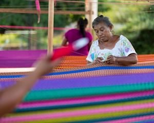 Woman weaving traditional Mayan hammock