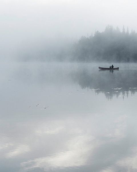 Canoe on a foggy pond in Adirondack Park in New York.