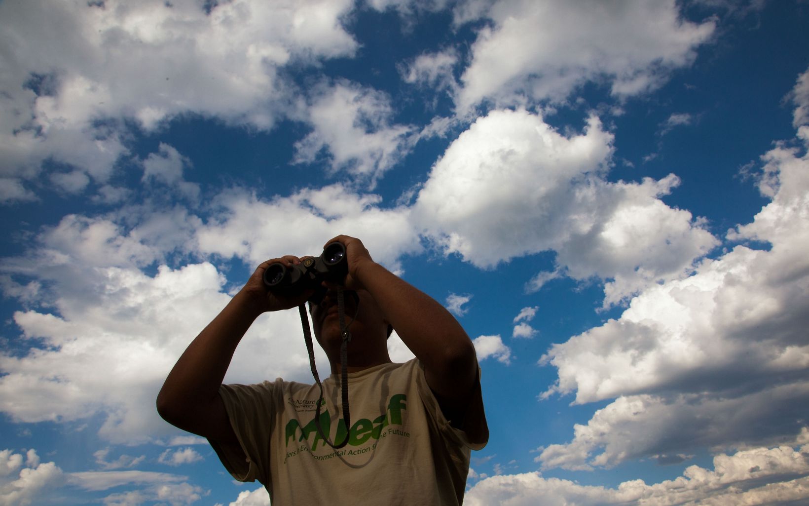 LEAF intern looks through binoculars near the preserve. 