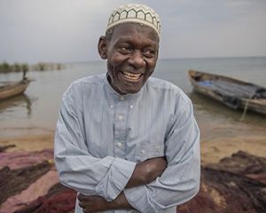 A man with arms crossed on the beach