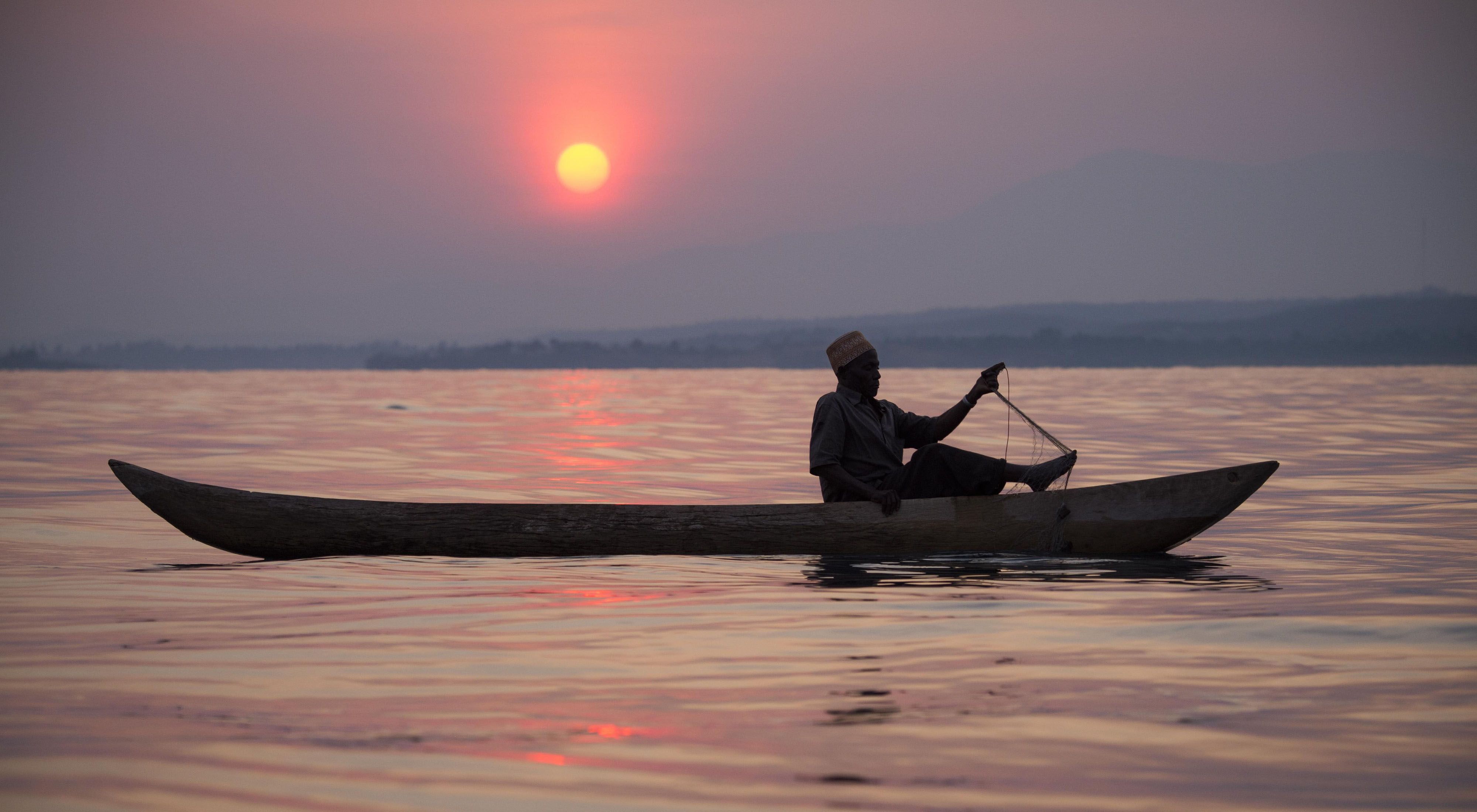Fisherman in a canoe on Lake Tanganyika at sunset.