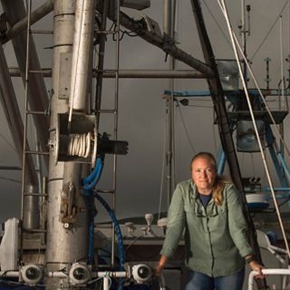 Portrait of Kate Kauer on the deck of a fishing boat.