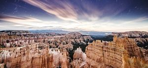 Landscape view looking across a vast chasm with large cliffs and rock formations in Bryce Canyon, Utah.