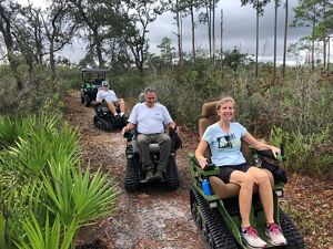 Volunteers trying track chairs in Tiger Creek Preserve to improve the trails accessibility.