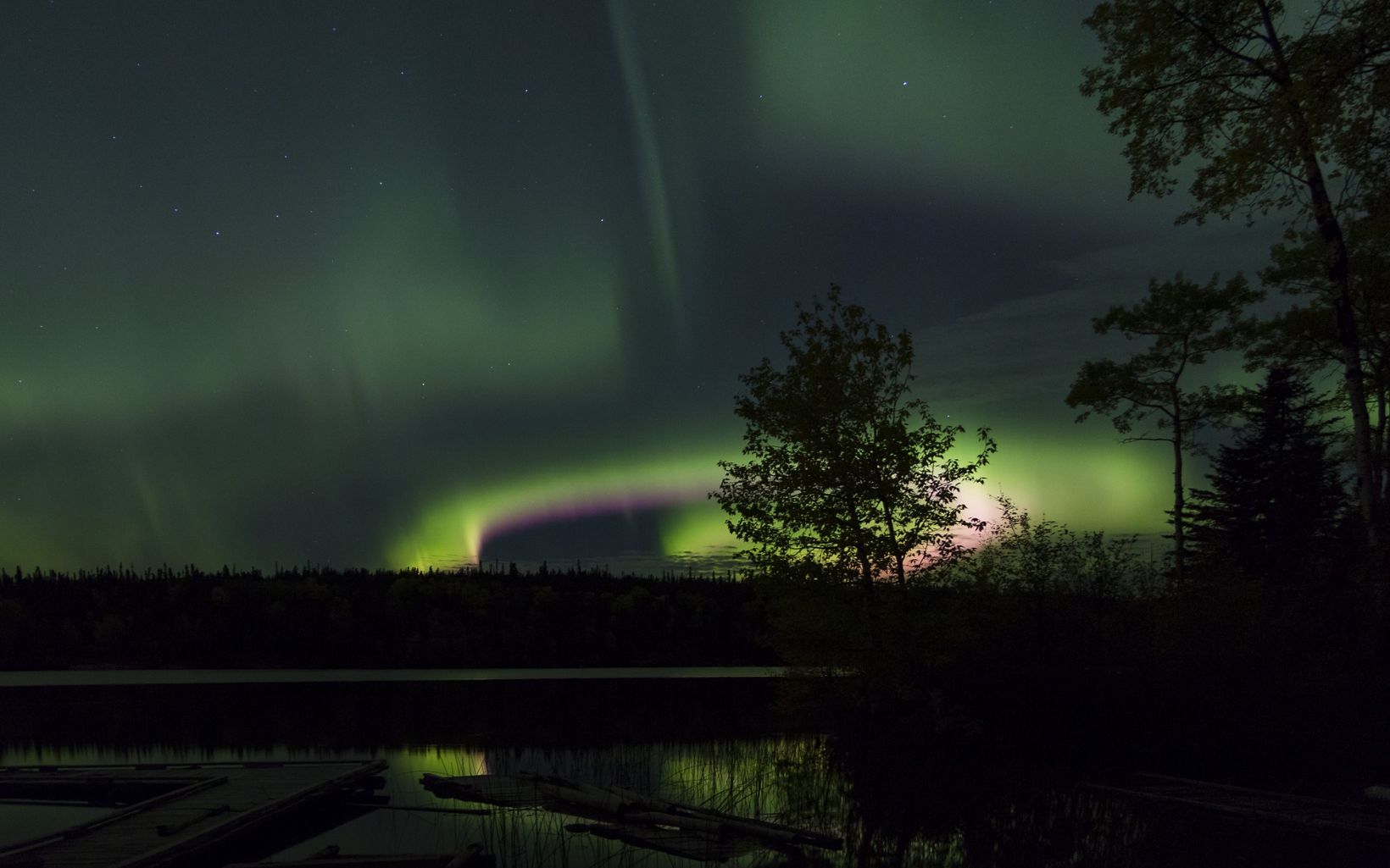 A vibrant display above the Kenanow Lodge in Sherridon, Manitoba, within the heart of Canada's boreal.