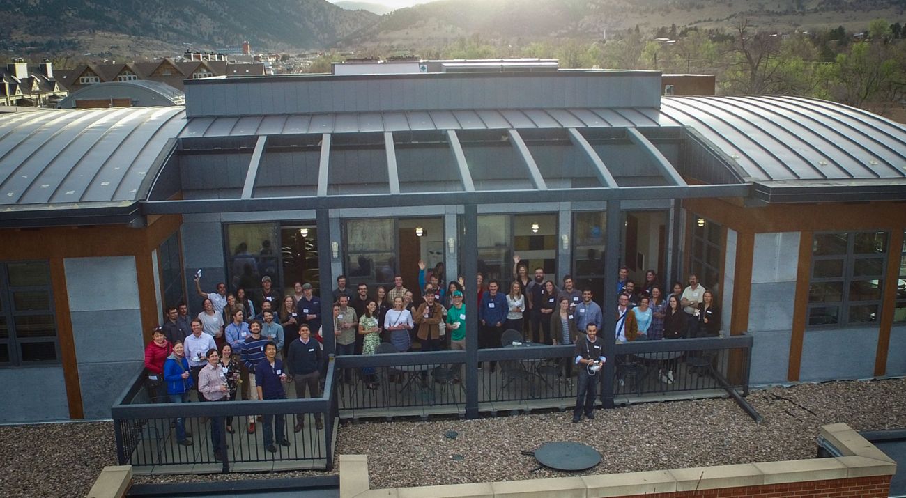 Group of people pictured on balcony at an office building.