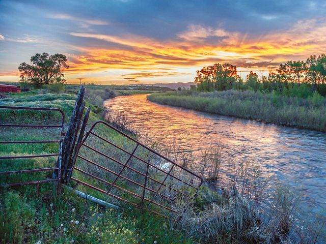 Sunset view of a river on a ranch.