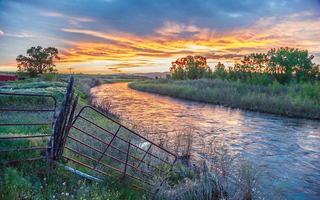 Sunset view of a river on a ranch.