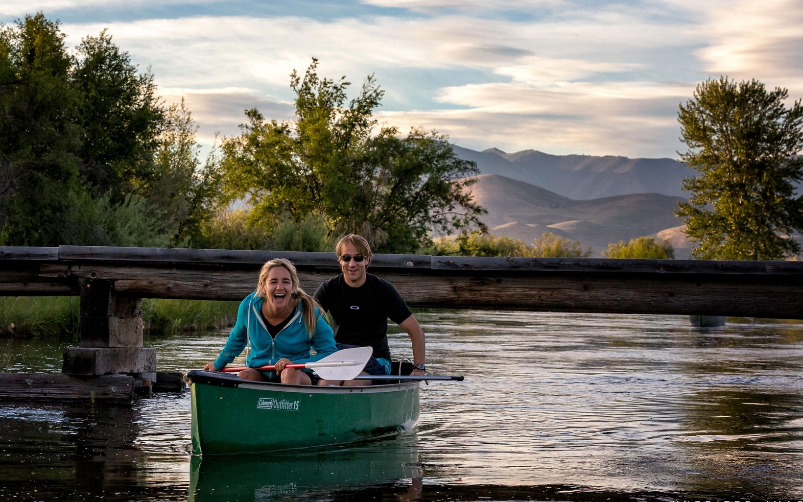 Two laughing people in a canoe on Silver Creek.