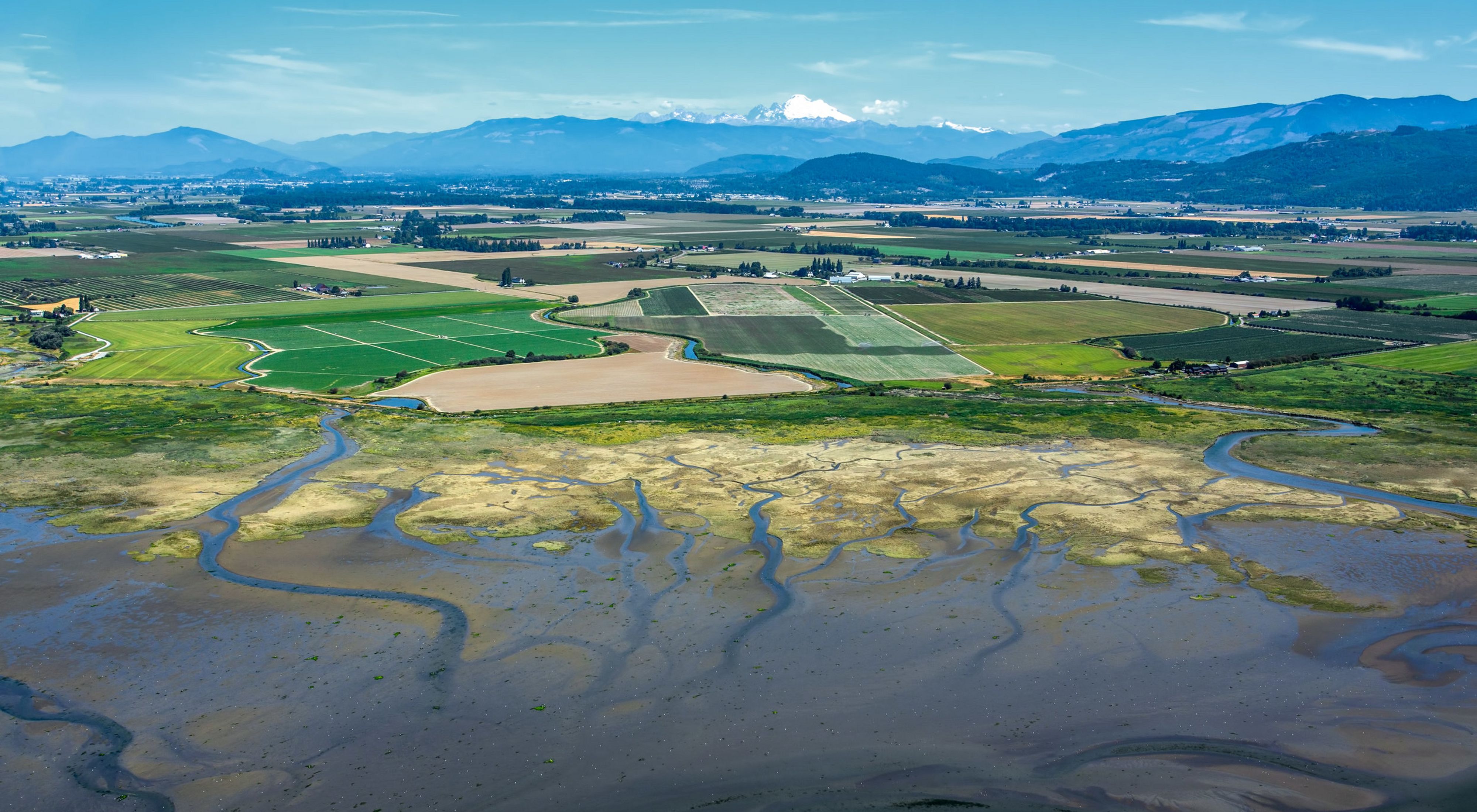 farms and floopdplains, amongst the Cascade Mountains in the background. 