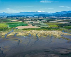 farms and floopdplains, amongst the Cascade Mountains in the background.