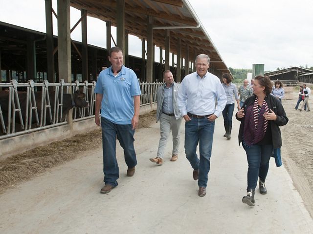 All Internal Rights. Jeremy Visser, left,  gives Governor Inslee, Jessie Israel (TNC), and others a tour around the dairy farm. Photo by Hannah Letinich. 