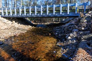 A new bridge allows a river to flow freely underneath.