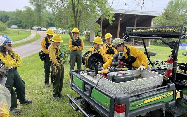 group of women going over fire equipment.