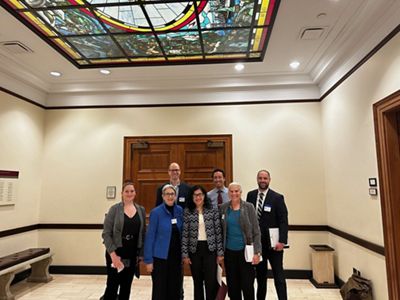 A group of people standing together smiling.