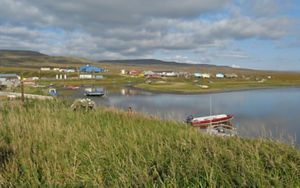 Scenic landscape view of a small fishing community on the edge of a body of water.