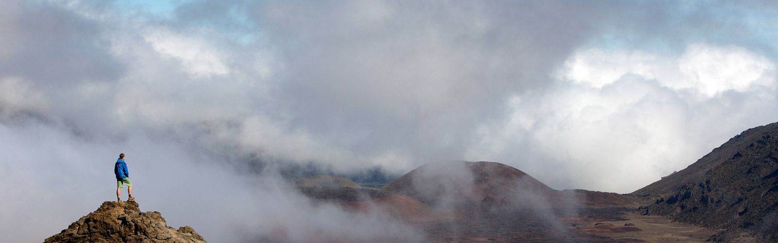 TNC staff Axel Brunst stands on a rock inside the creater of Haleakala National Park.