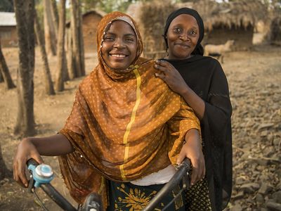 Community-based distributors ride bikes door-to-door offering family planning information in the village of Mgambo near Lake Tanganyika.