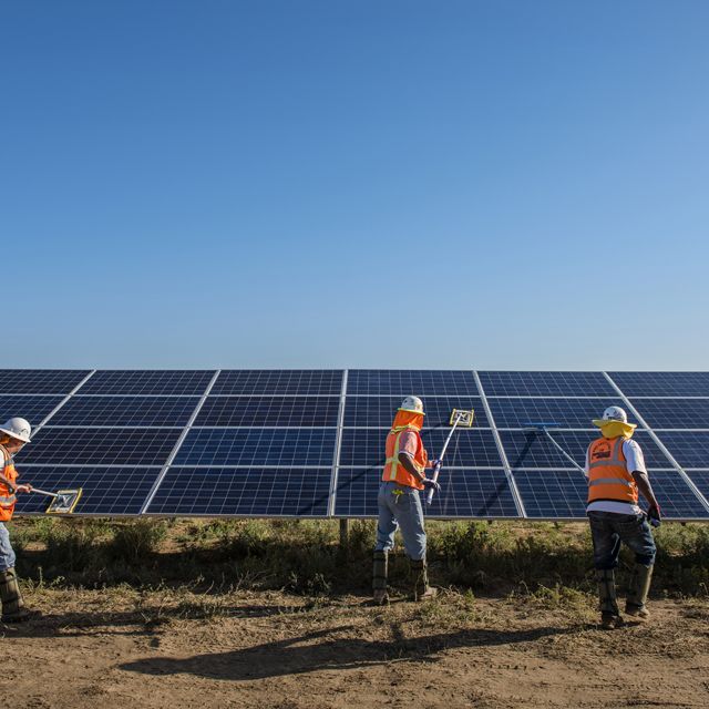 Worker's clean solar panels for maximum efficiency at the power solar facility in Lancaster, California. Photo credit: © Dave Lauridsen