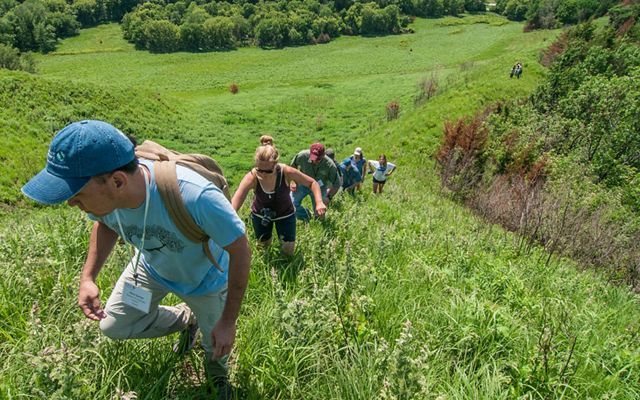Group of hikers making their way to a high point in the Loess Hill of Iowa that is home to tremendous diversity of plants and animals which are resilient to climate change.