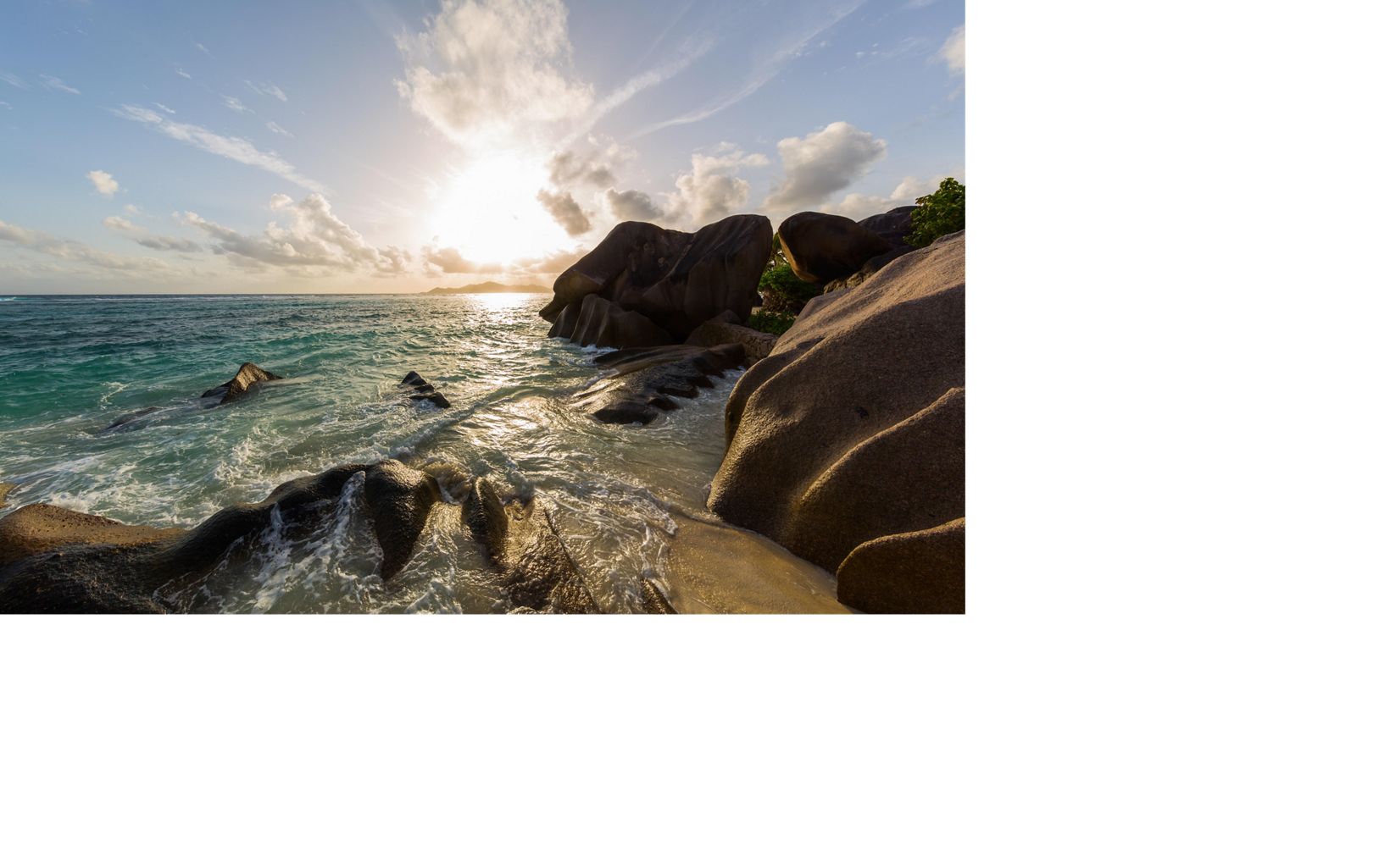 Worn granite rocks in the surf and sand define the coastlines of Seychelles's inner islands. 